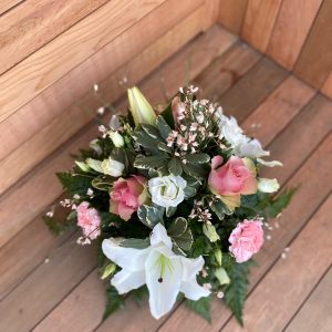 A tranquil and peaceful posy tribute. A selection of pink and white pretty flowers and subtle foliage. Available in other colours. Same day delivery. Due to seasonal variations some items may be substituted to produce a display of equal quality and value. Professionally arranged by our expert florists with care. Delivered by hand by our own driver. Click & collect is also available
