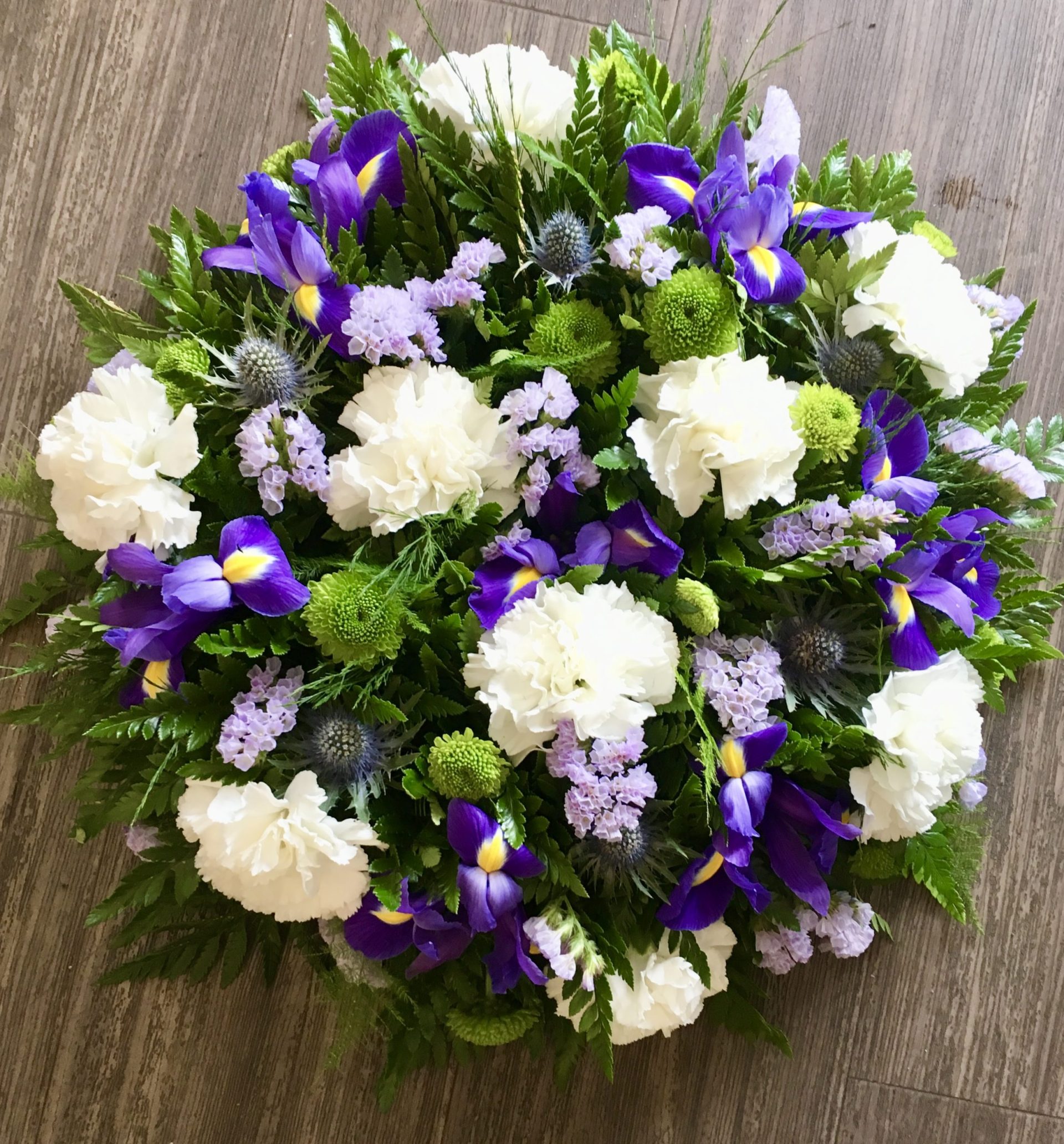 A charming posy pad in delicate shades of lilac blue and white. Available in any colours. Same day delivery. Due to seasonal variations some items may be substituted to produce a display of equal quality and value. Professionally arranged by our expert florists with care. Delivered by hand by our own driver. Click & collect is also available