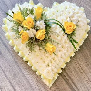 This lovely heart shaped tribute is available in any colour. (Suitable for a baby or to a grandparent/parent off a baby.) White solid massed heart with ribbon edge and a small cluster spray to the one side. 24 hours notice needed or similar design for same day delivery. We can offer delivery by our own drivers or click and collect is available. Professionally arranged by our expert florists with care. Due to seasonal variations some items may be substituted to produce a display of equal quality & value.