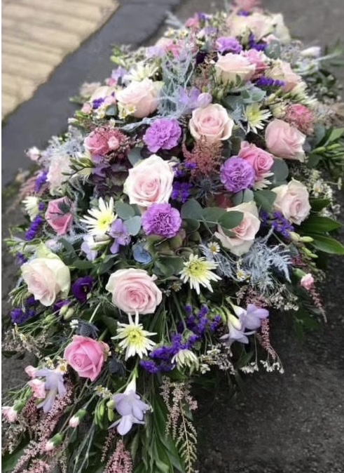 A delicate casket spray with red roses with soft subtle foliage's. Please state in the order form notes what colours you would like.24 hours notice, or similar designDue to seasonal variations some items may be substituted to produce a display of equal quality and value.Same day Delivery.Professionally arranged by our expert florists with care.Delivered by hand by our own driver.Click & collect is also available