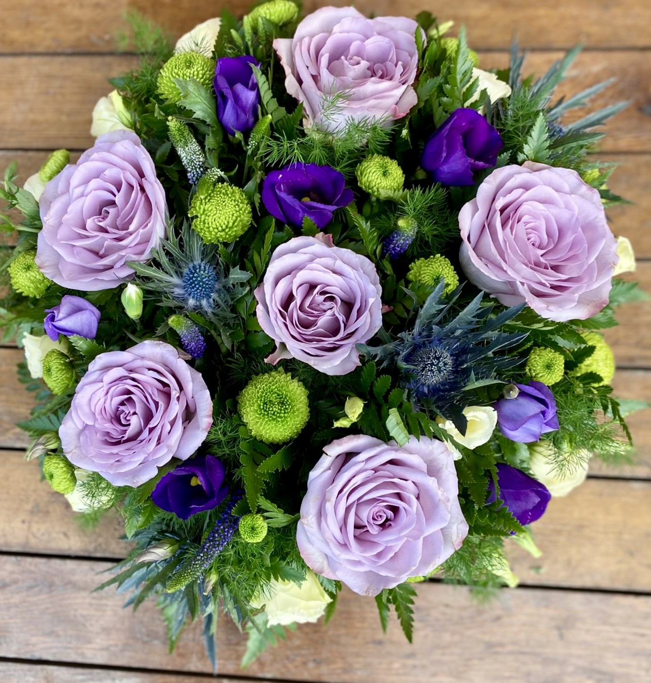 A charming posy pad in delicate shades of lilac blue and white. Available in any colours. Same day delivery. Due to seasonal variations some items may be substituted to produce a display of equal quality and value. Professionally arranged by our expert florists with care. Delivered by hand by our own driver. Click & collect is also available