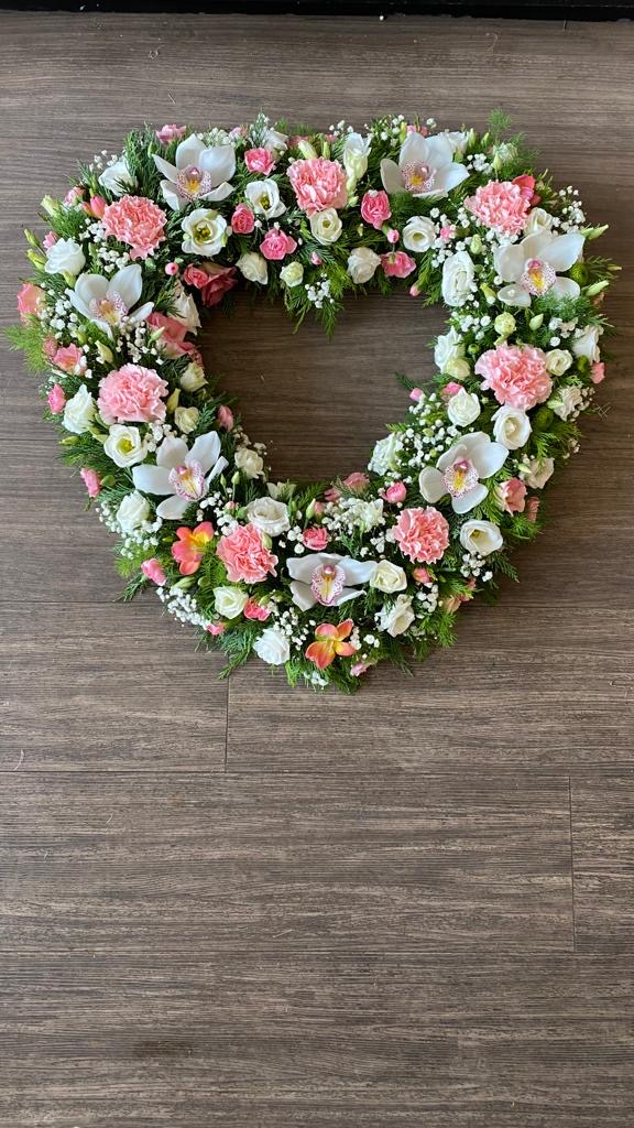 A pretty and delicate open heart can be in any colours of your choice. Same day delivery. Due to seasonal variations some items may be substituted to produce a display of equal quality and value.