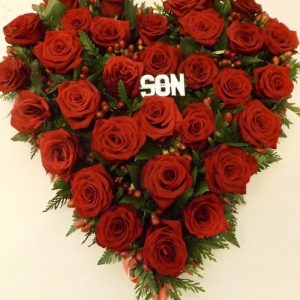 All red rose Heart tribute.beautifully crafted arrangement symbolising the loss of your sole mate or loved one. This elegant heart tribute features a delicate balance of red roses for passion and love with lush foliages. A touching tribute to honour the life of a loved one who has passed.Handcrafted with care by our expert florists, this tribute is available for delivery to funeral homes or directly to the family, ensuring a meaningful and timely gesture in their time of need.
