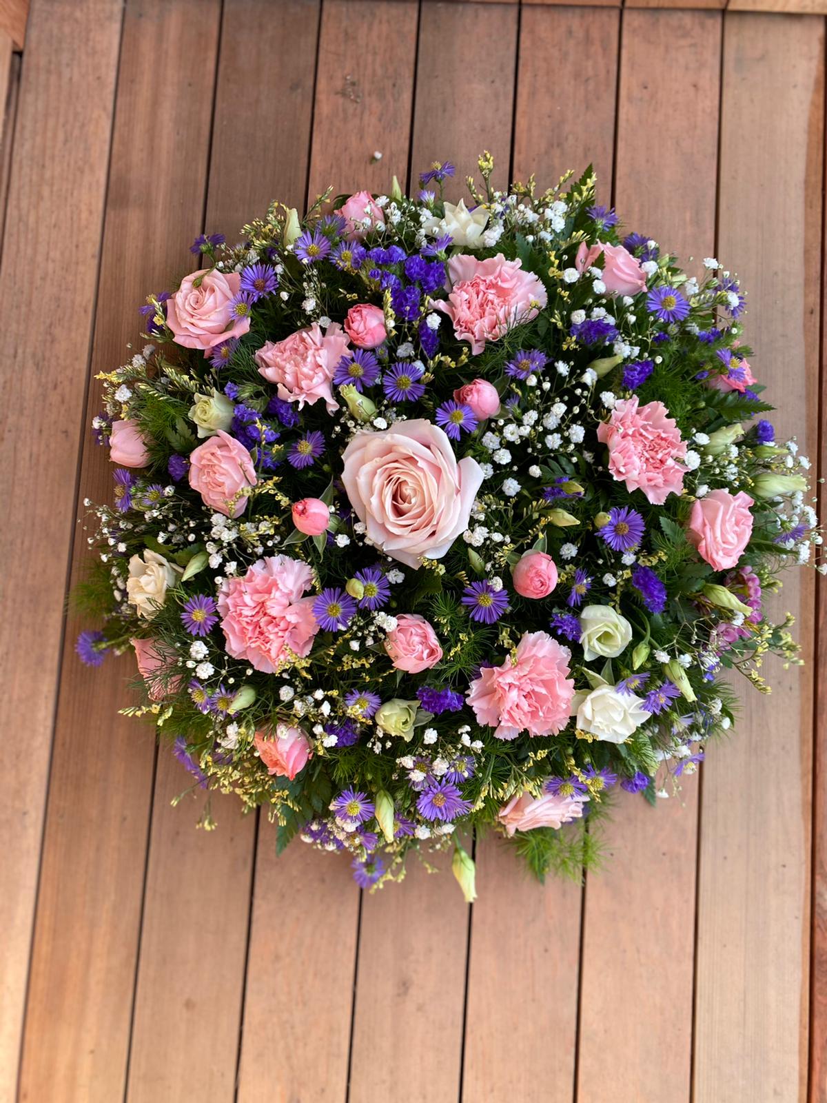 A charming posy pad in delicate shades of lilac blue and white. Available in any colours. Same day delivery. Due to seasonal variations some items may be substituted to produce a display of equal quality and value. Professionally arranged by our expert florists with care. Delivered by hand by our own driver. Click & collect is also available