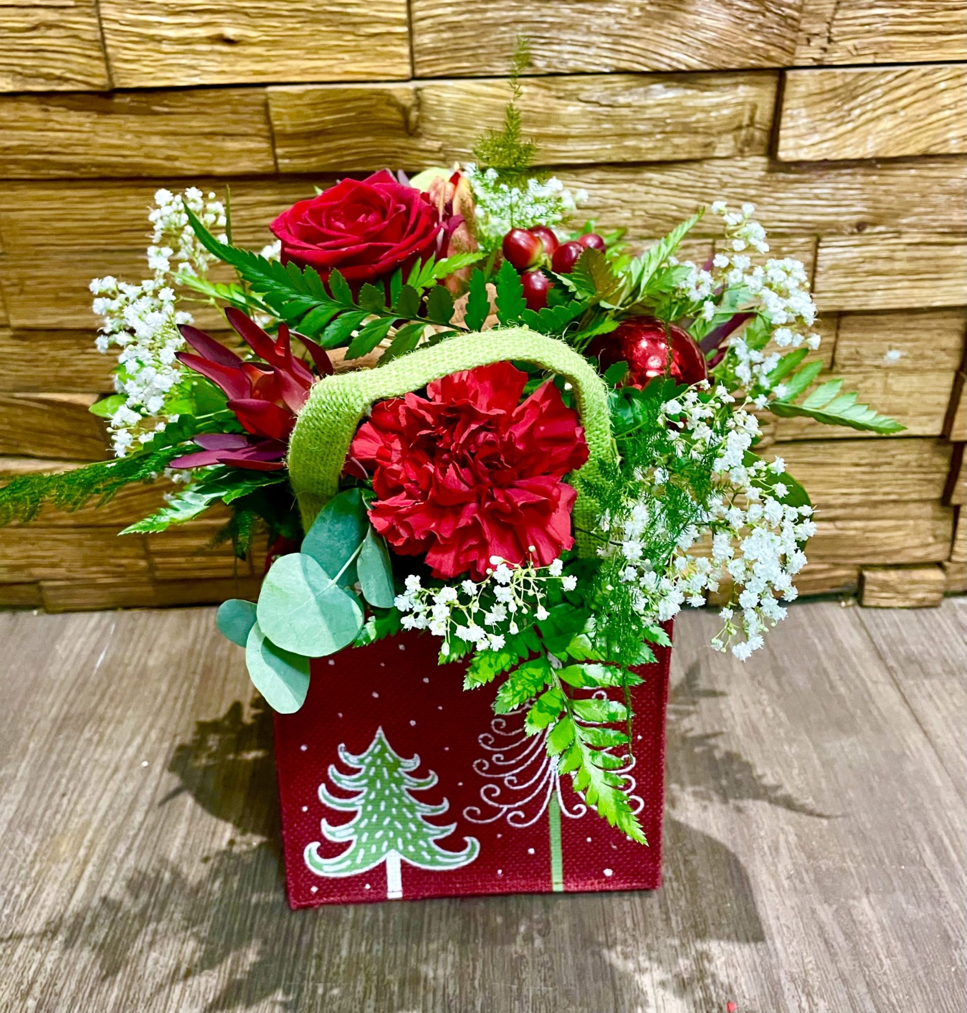 a selcetion of fresh christmas foliage and flowers perfect treat for someone special