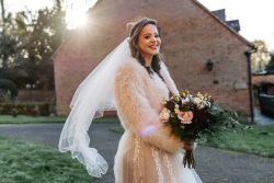 Bridal bouquet of baby pink sweet avalanche & burgundy flowers perfect for a winters wedding with trails of soft foilages
