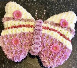 A beautiful butterfly funeral tribute Colours of your choice.24hrs notice required Due to seasonal variations some items may be substituted to produce a display of equal quality and value.Professionally arranged by our expert florists with care.Delivered by hand by our own driver.Click & collect is also available.
